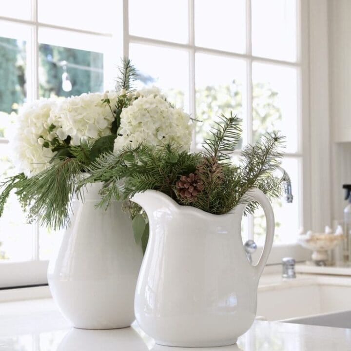 Image for White Pitchers Filled With Winter Greens