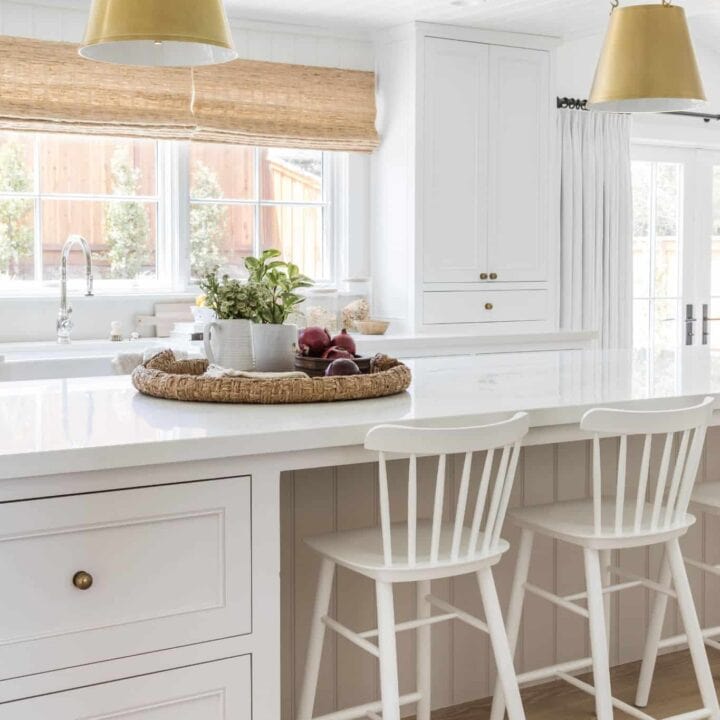 Image for White Cabinetry, Golden Pendant Lights, & Woven Tray Centerpiece