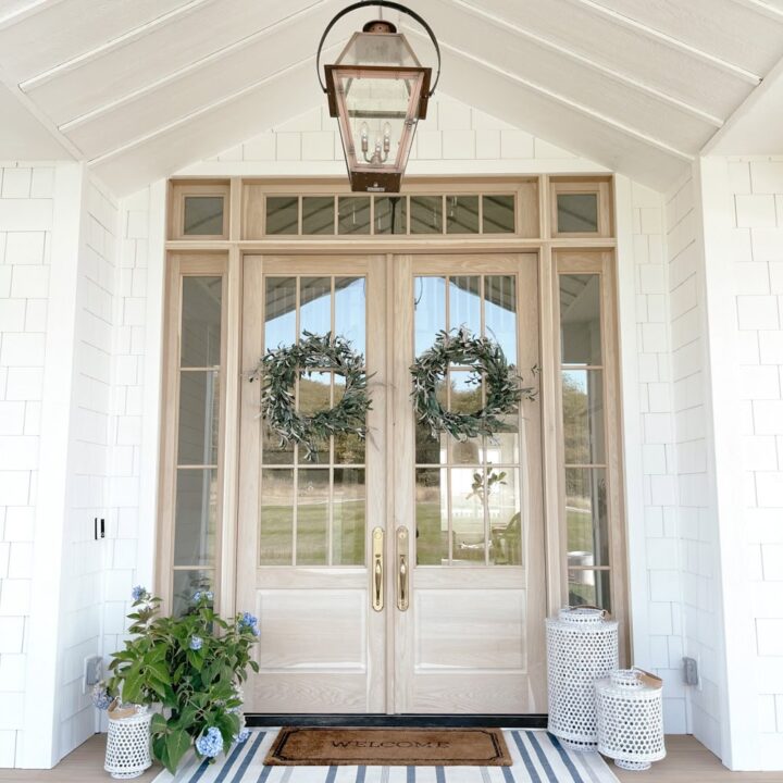 Image for Light Wood Double Doors With Matching Wreaths, Striped Rug & Flowers