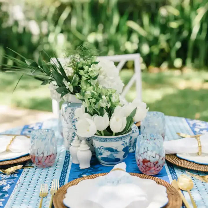 Image for White Floral Centerpiece, Blue Patterned Tablecloth, and Gold Accents