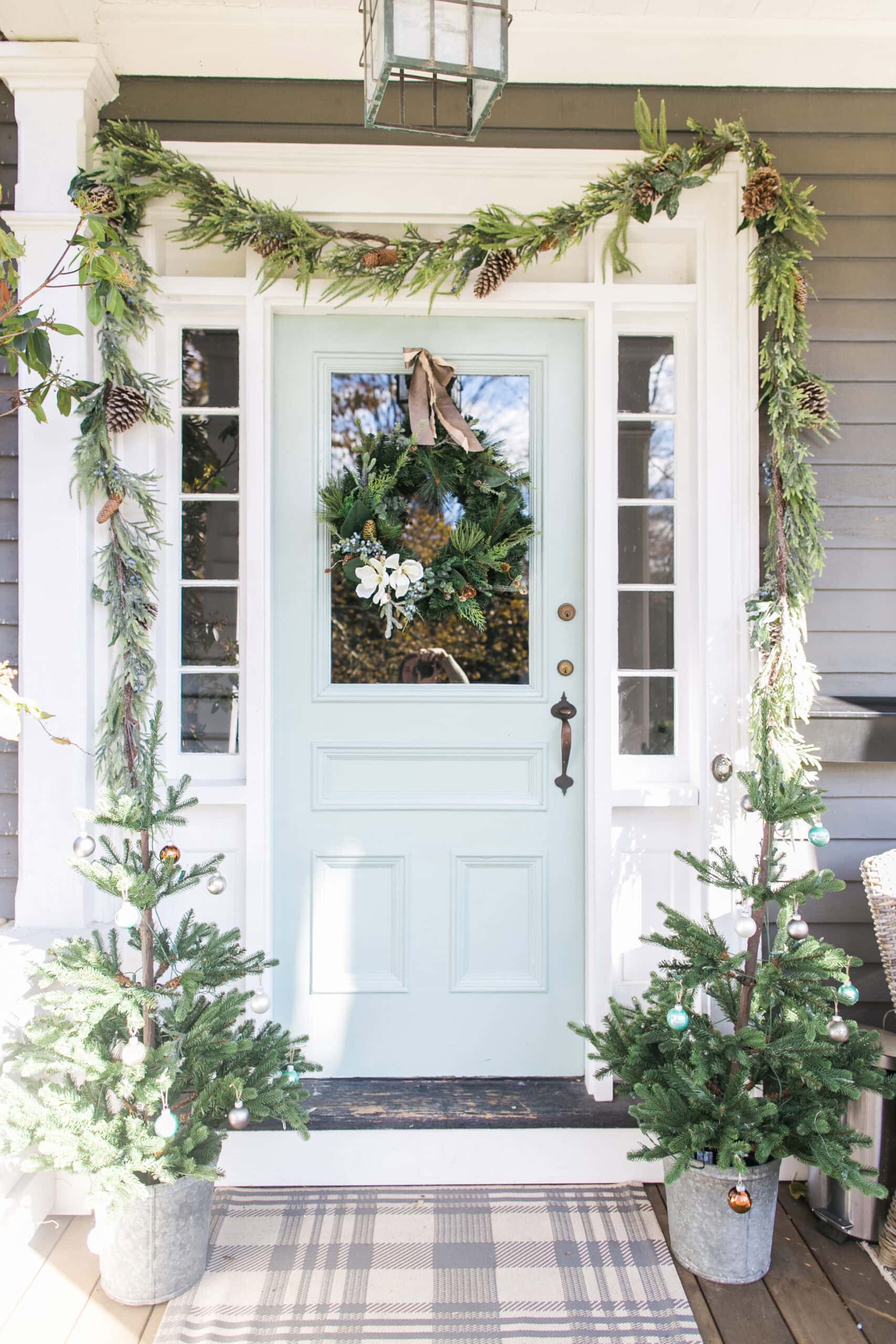 Cozy holiday home entrance decorated with greenery and a festive wreath.