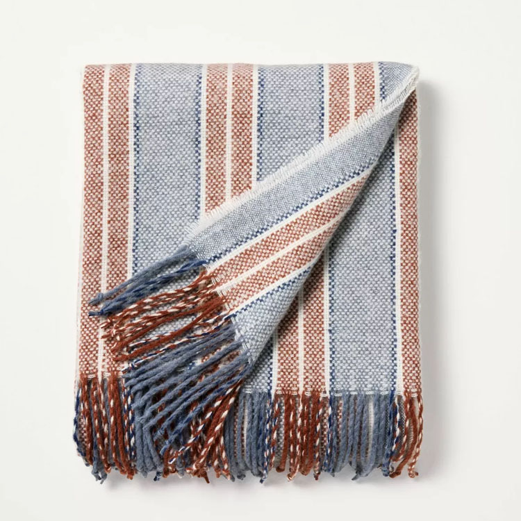 This blue and brown striped throw blanket is a must have for fall! #ABlissfulNest